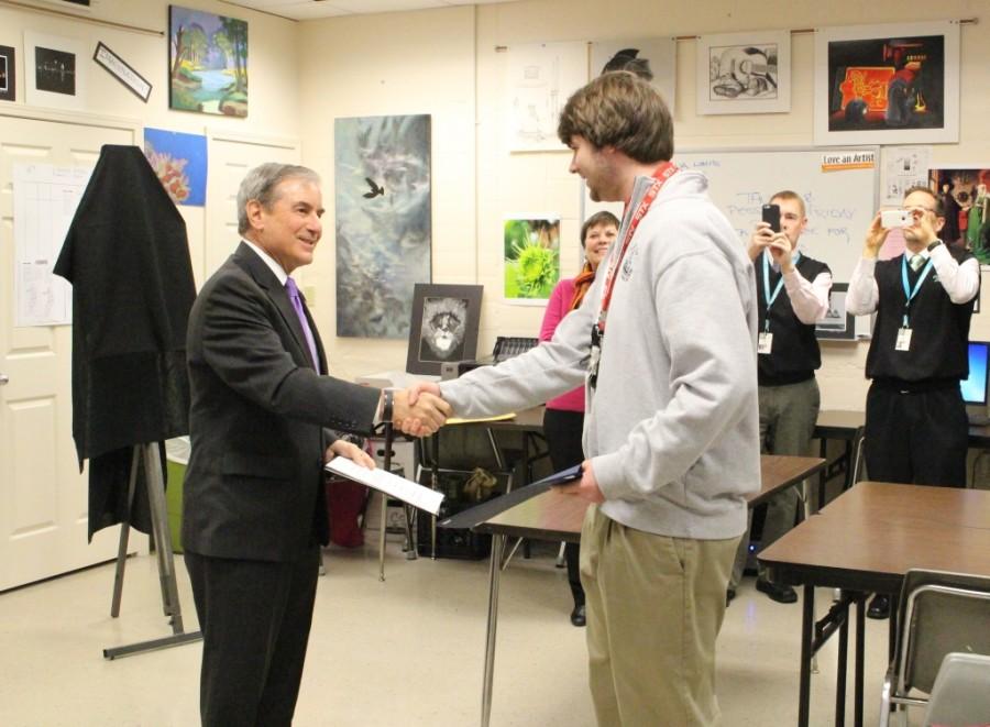 Congressman John Yarmuth congratulates senior Ben Kline on winning the 2015 Congressional Art Competition.