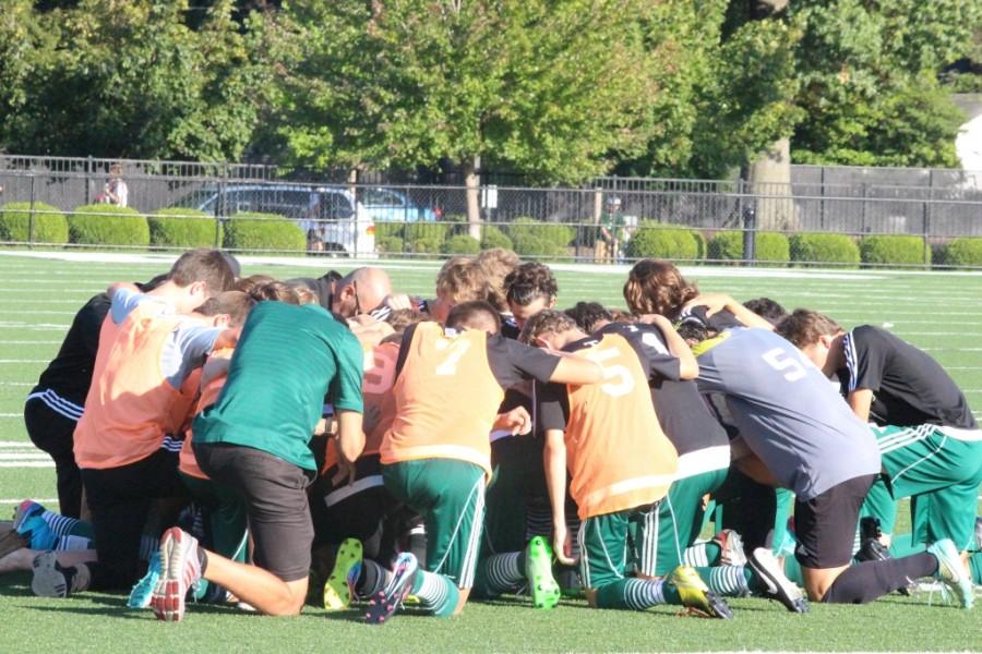 The soccer Rocks knelt in prayer before taking on Salesianum (DE) at home on Sept. 19.  The Rocks won 2-0. 