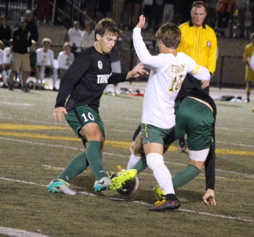 Trinity's Luke Williams fights for the ball. The Rocks knocked off the Tigers 2-1, for a seventh consecutive win over St. Xavier.