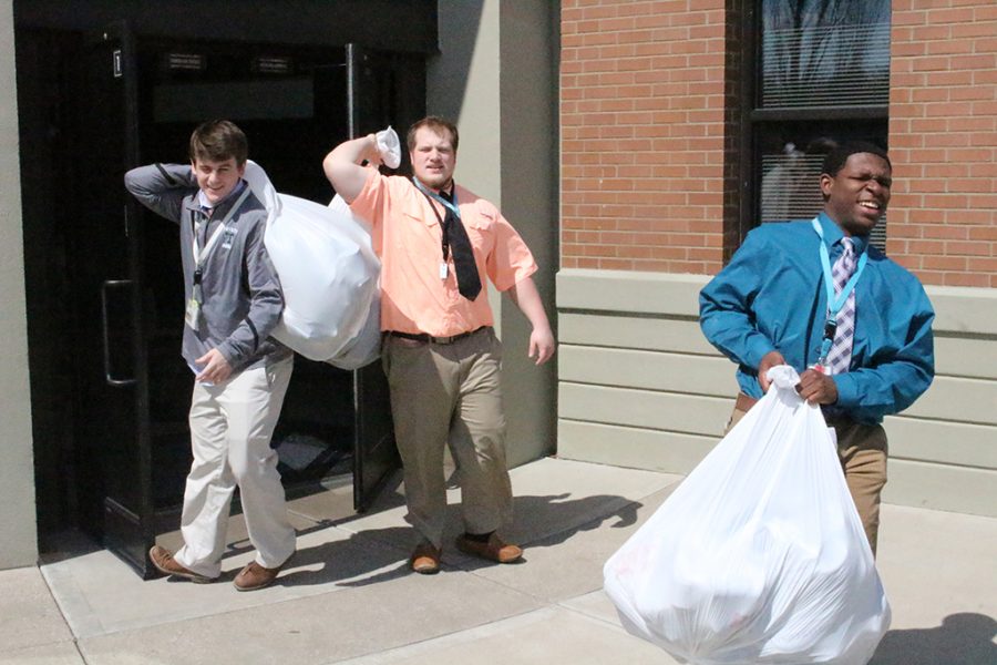 Bags of shoes are carried to the WaterStep truck Mar. 28. 
