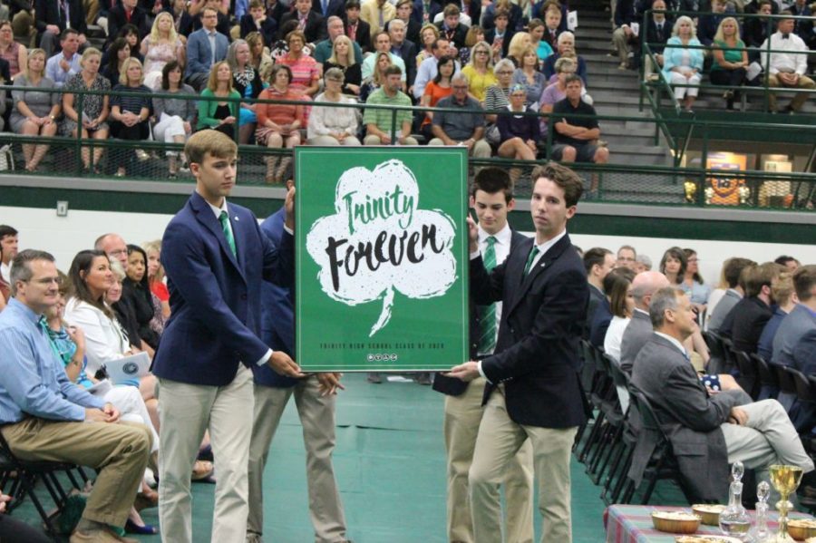 Senior Class officers displayed the year's theme poster during the annual Opening Mass.