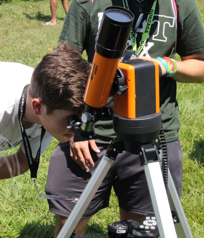 Scanning the heavens -- Trinity students gaze through a telescope during the Aug. 11, 2018, solar eclipse. 