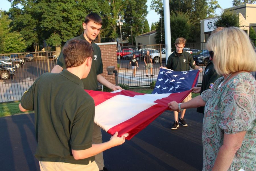 The Trinity Senior Flag Corps lowers, presents and raises the flag before every home football game.