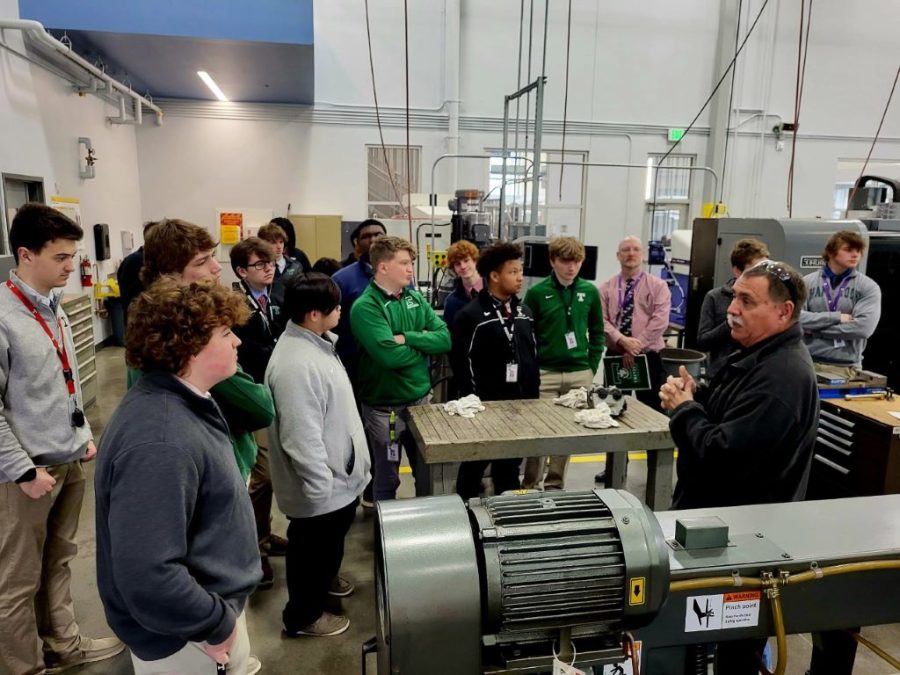 Students hear from professors about computer-aided manufacturering systems at the AMIT center.